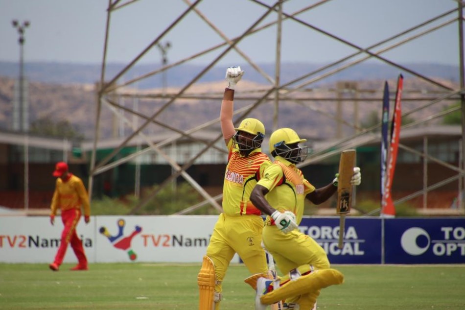 Kenneth Wasiwa and Dinesh Nakrani celebrate Uganda's win over Zimbabwe at the 2023 T20 World Cup Qualifier Africa finals